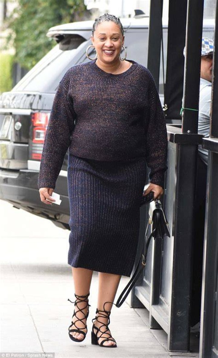 Pregnant Tia Mowry covers her growing baby bump in chic wardrobe